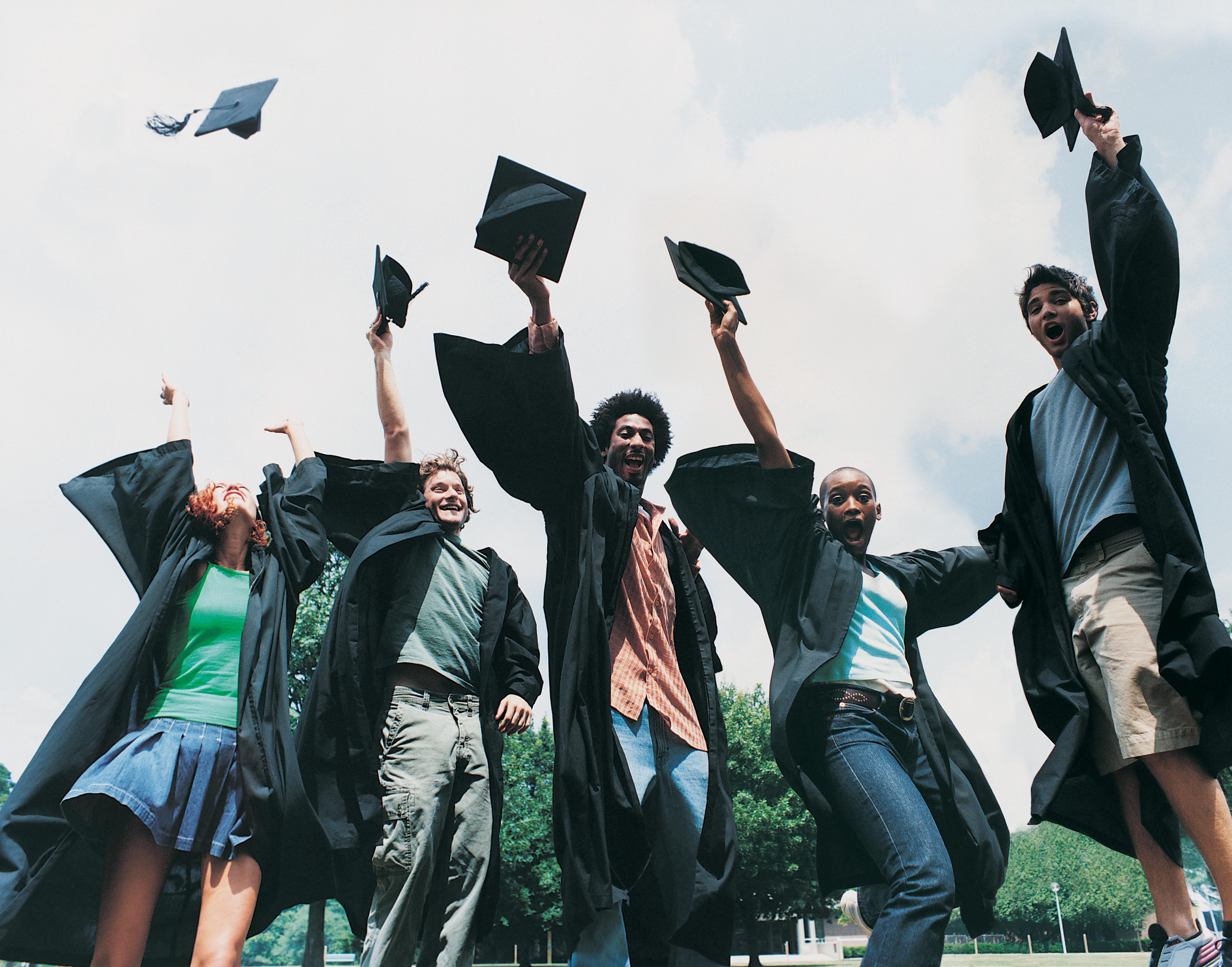 Five Students Jumping for Joy at Graduation
