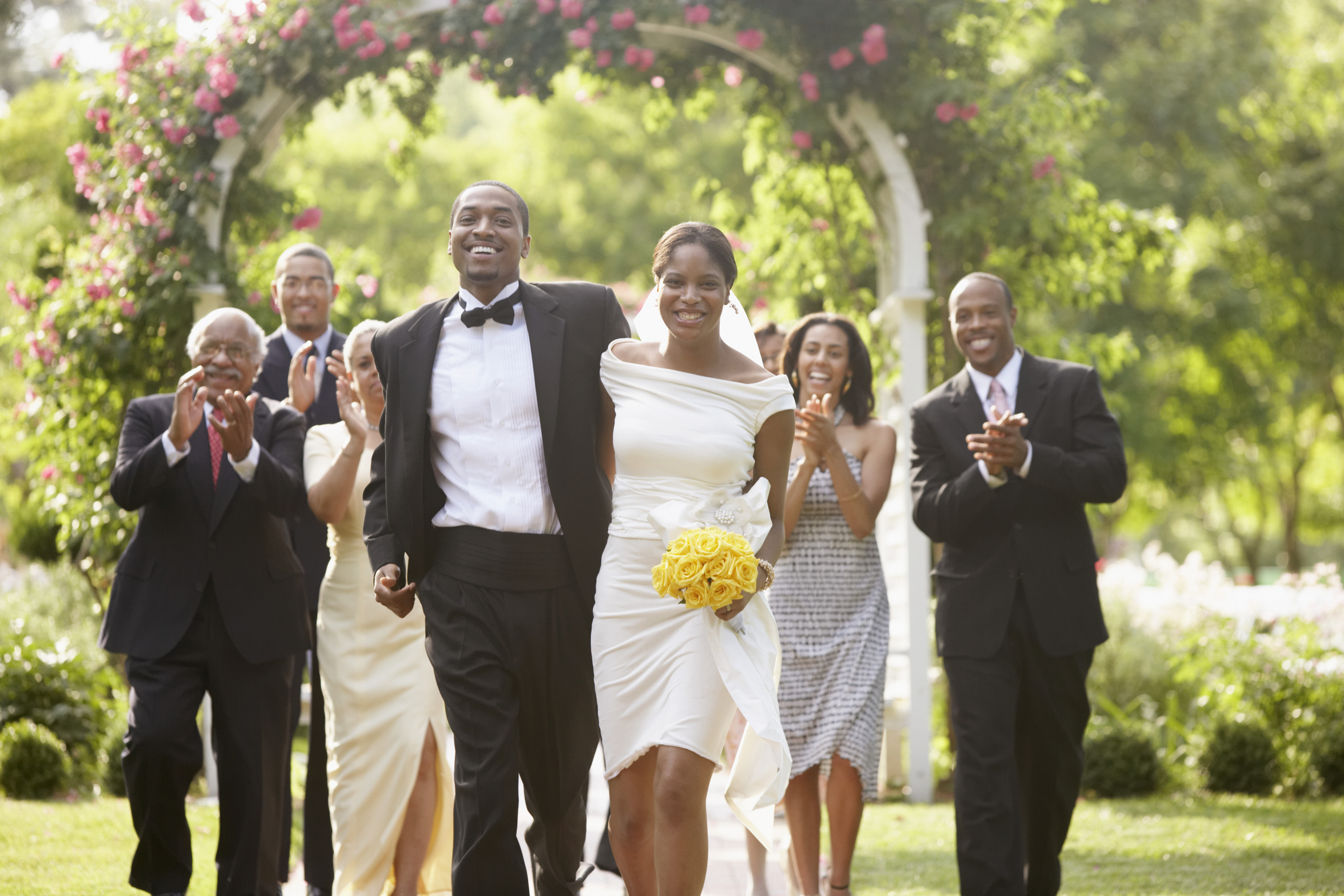 Wedding guests applauding newlyweds