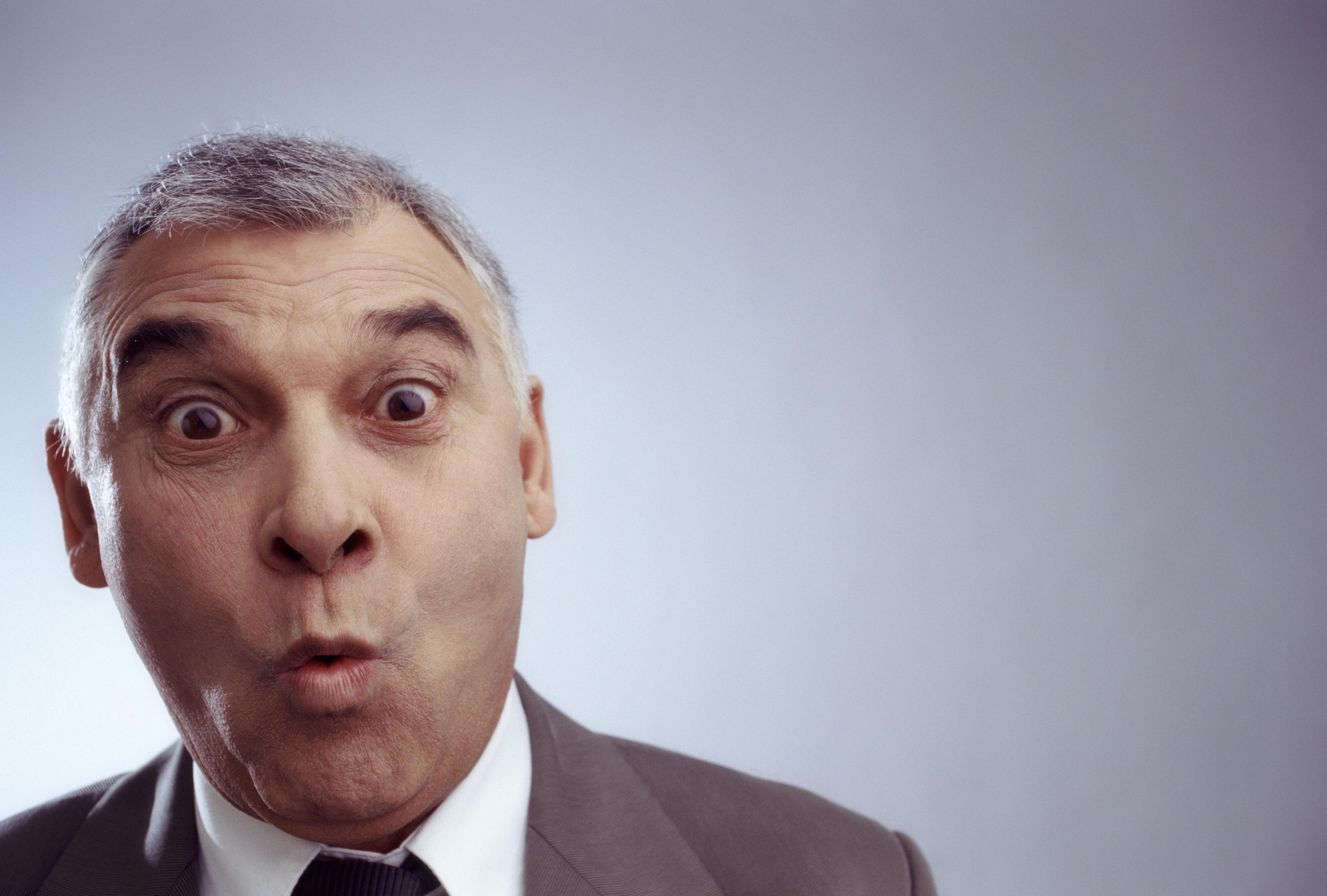 Close up of businessman pursing lips with eyebrows raised