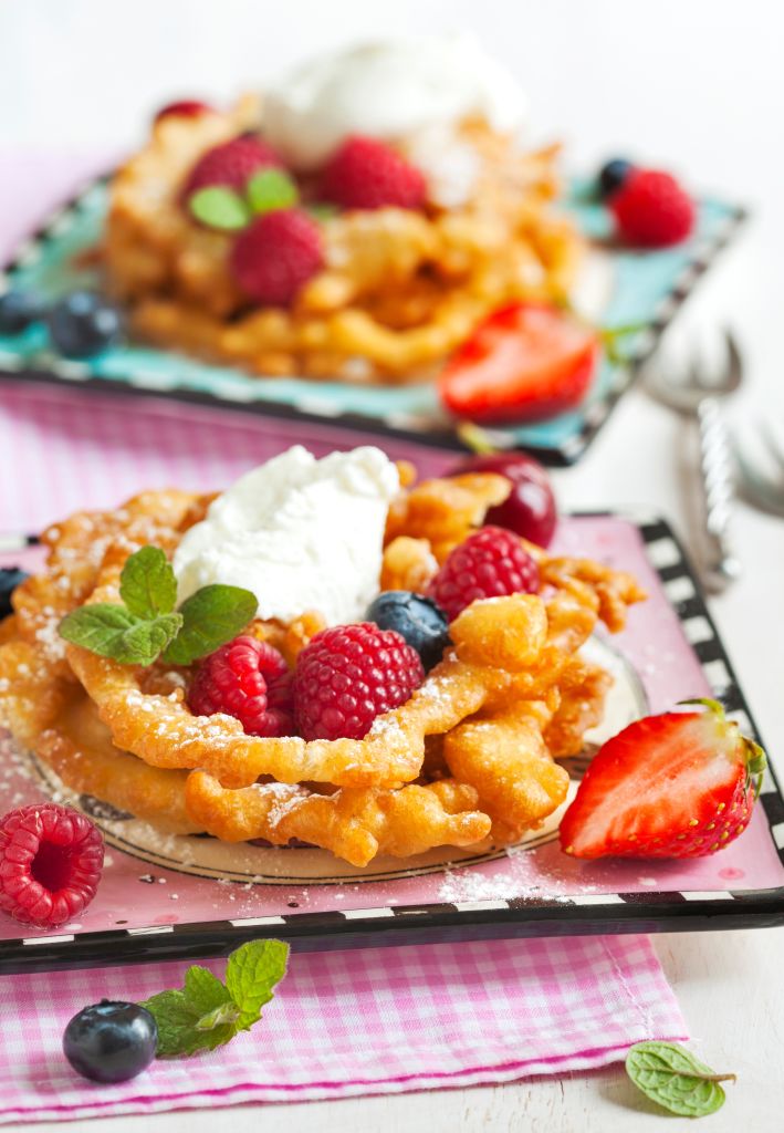 Funnel cakes with fresh berries and whipped cream