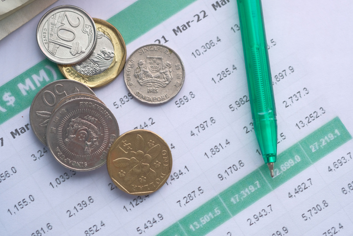 coins , pen and accounting data