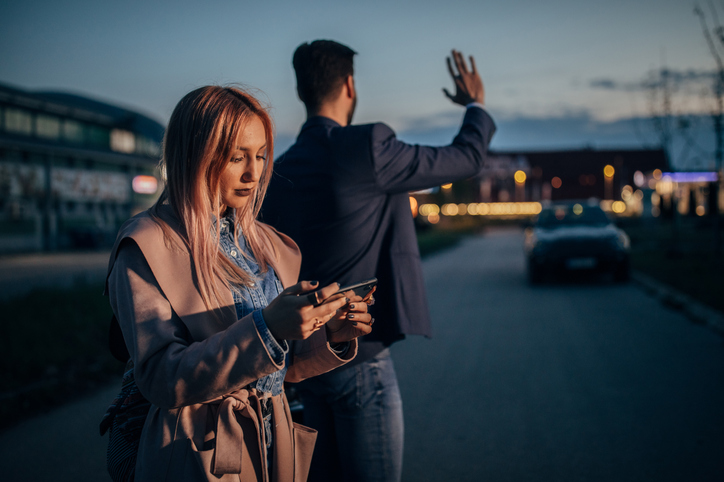 Fashionable couple catching taxi