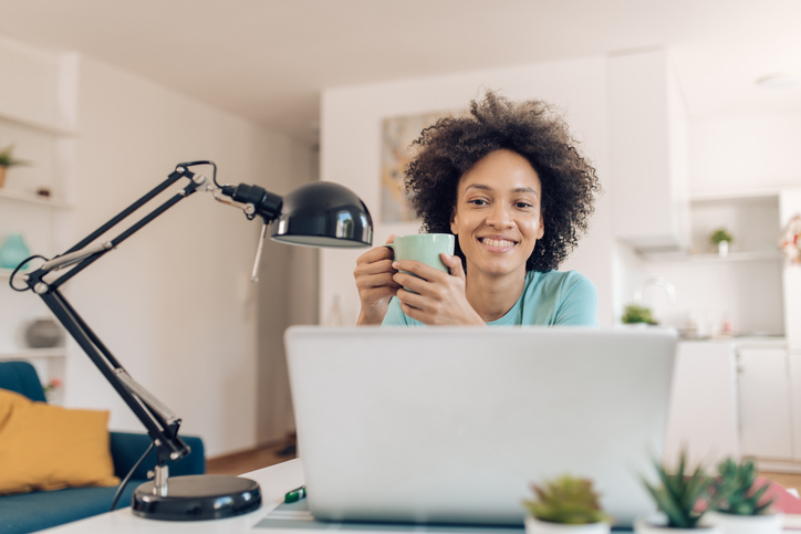 Portrait of a beautiful African American woman freelancing and enjoying