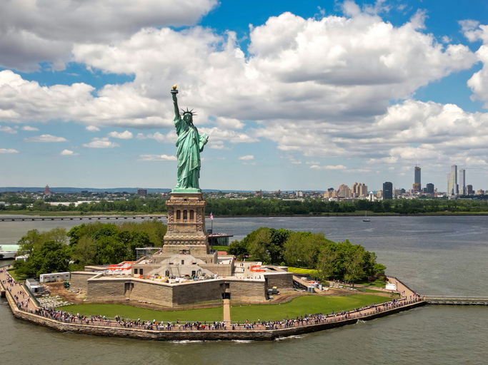 New York City with statue of liberty photo from drone. Aerial view of statue of liberty skyline in Manhattan. NYC, NY. Cityscape near statue of liberty. Famous statue of liberty of New York.