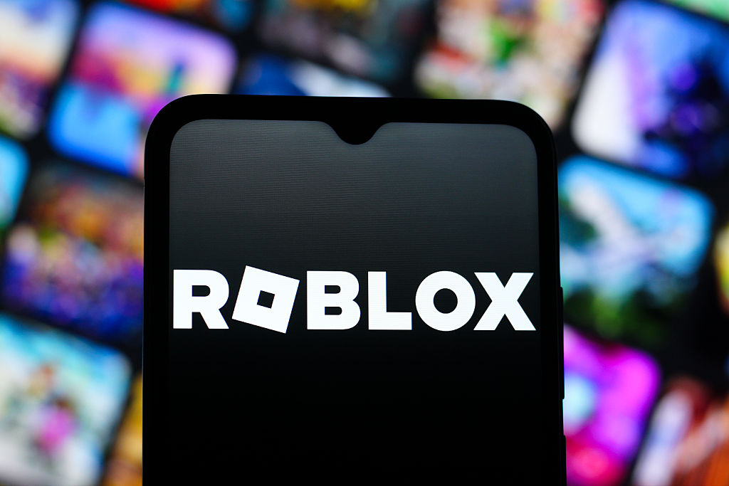 In this photo illustration, the Roblox Corporation logo is...